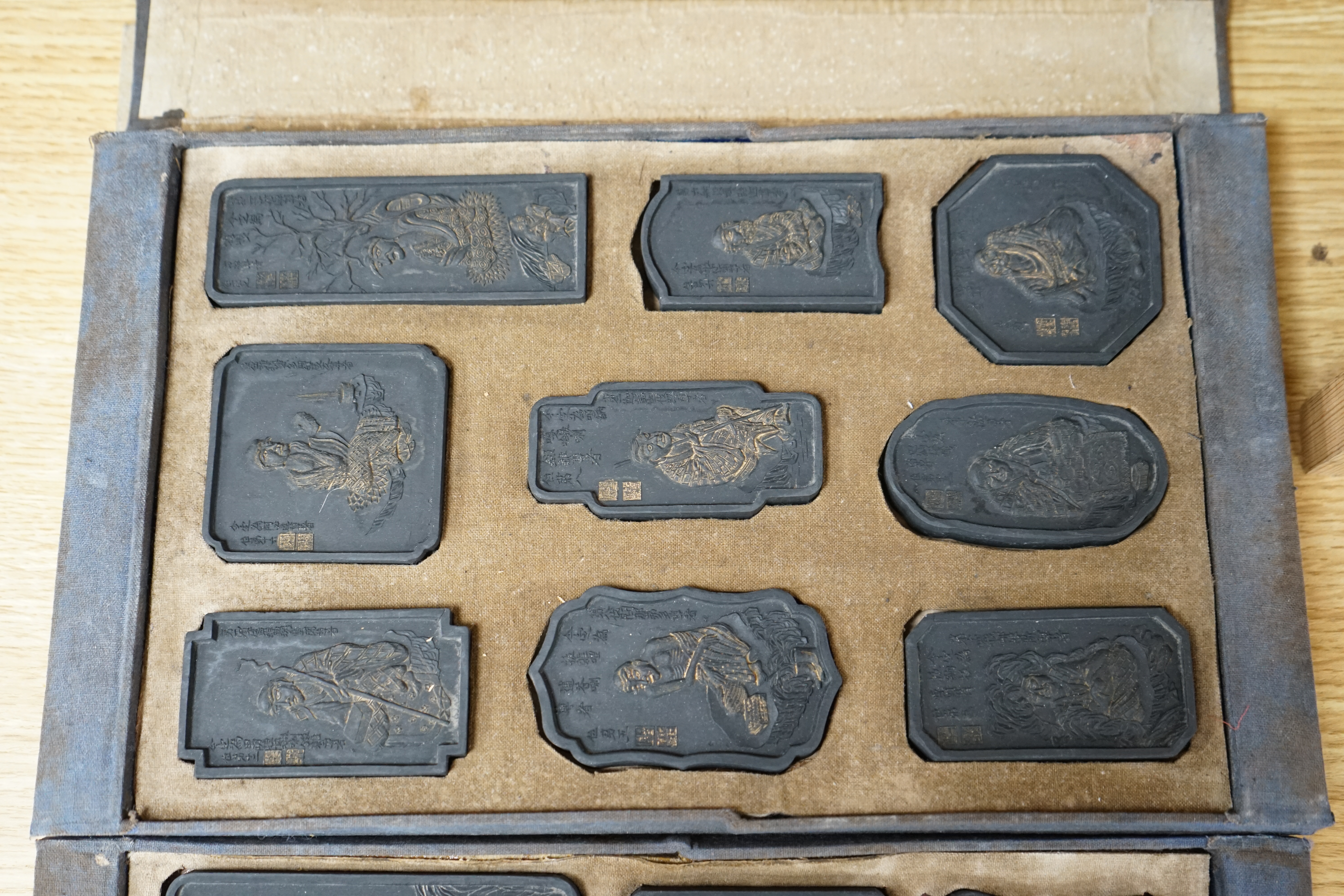 A boxed set of carved Chinese ink stones. Condition - worn